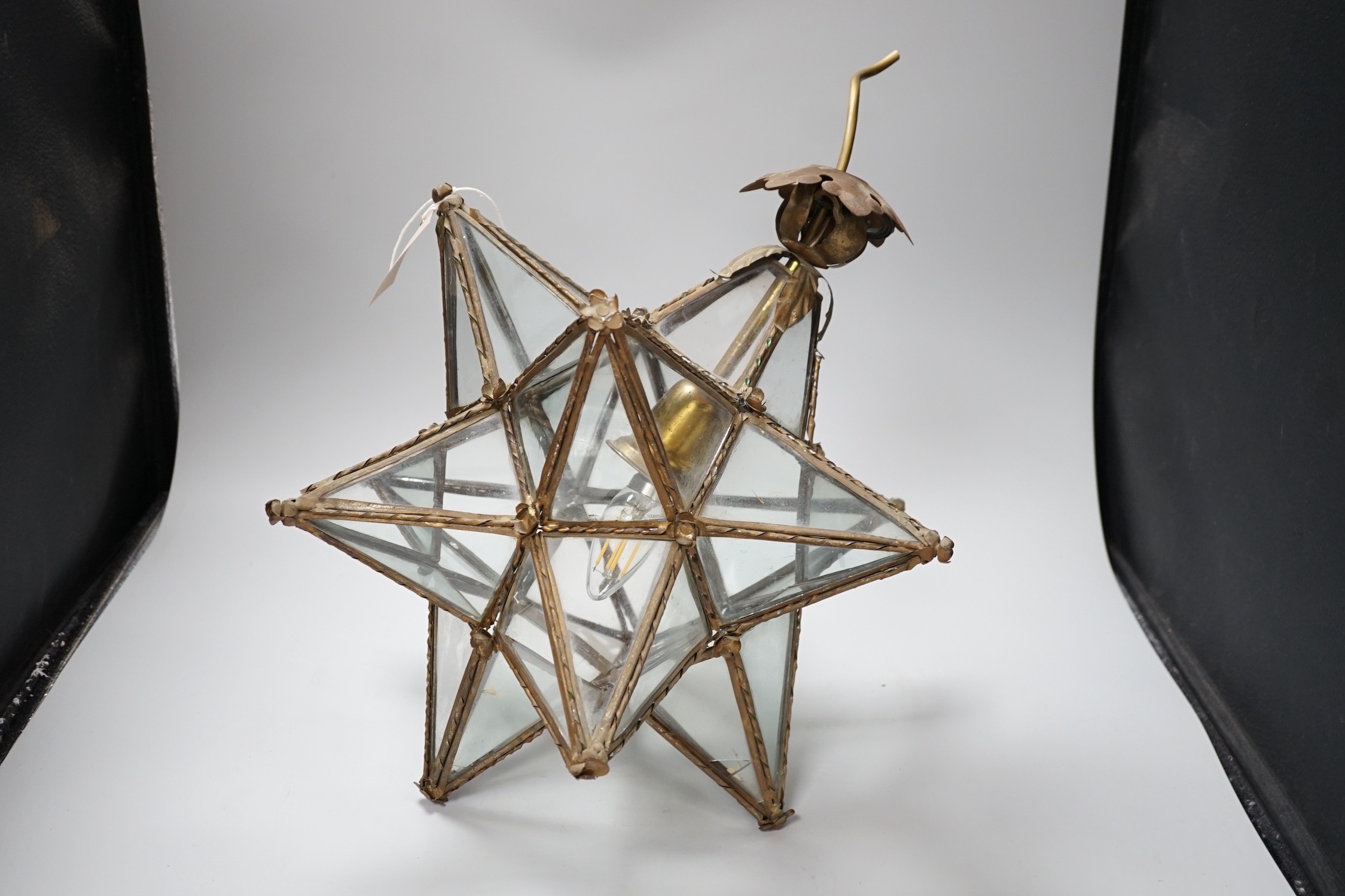 A cut glass four branch electrolier, star shaped gilt metal ceiling shade and a 1970's perspex ceiling shade